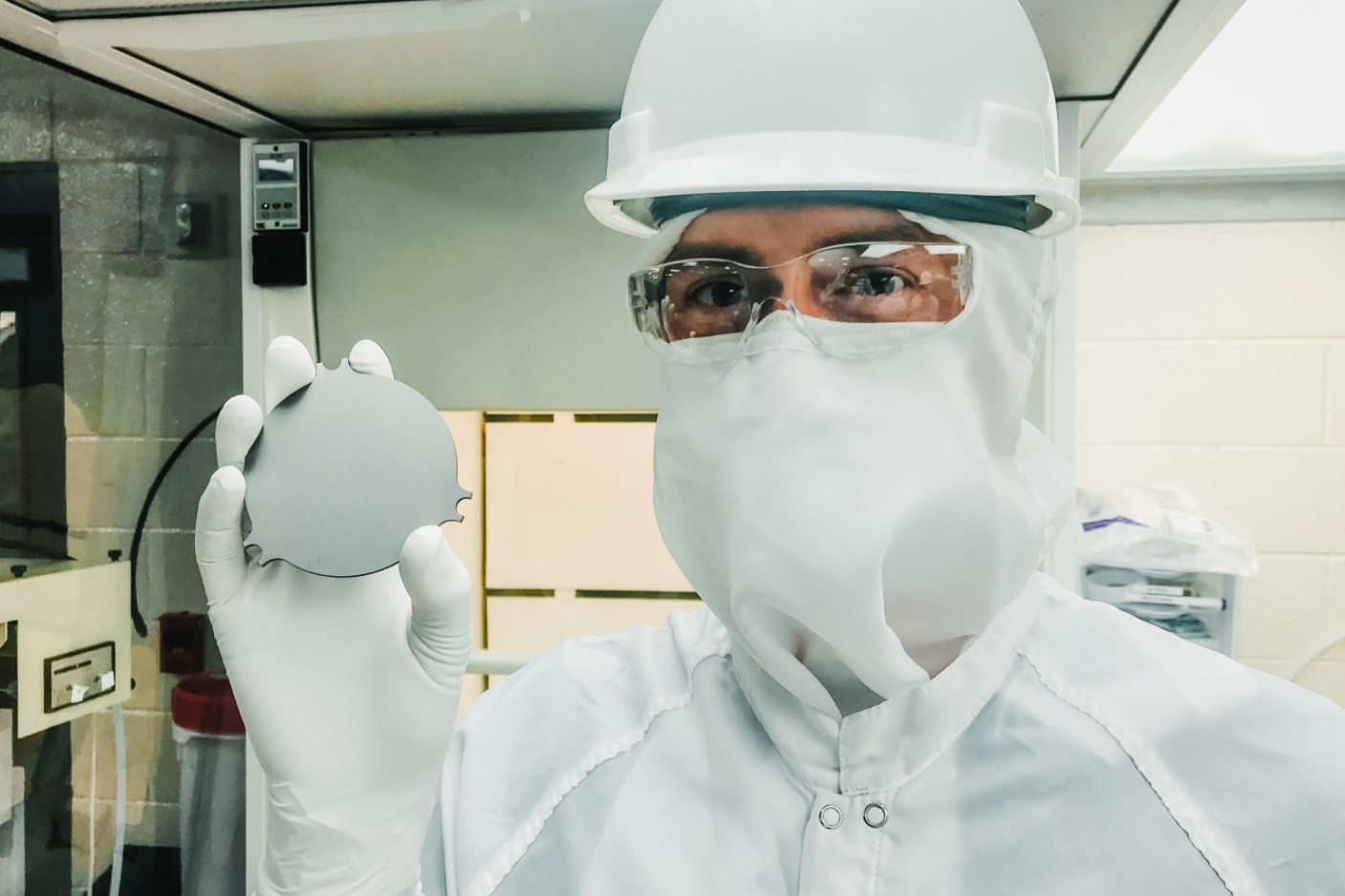 Samuel Meijer, staff scientist at Los Alamos National Laboratory, holds a tantalum plate in a cleanroom on the 4850 Level of Sanford Underground Research Facility, where a new experiment is searching for the decay of nature’s rarest isotope.