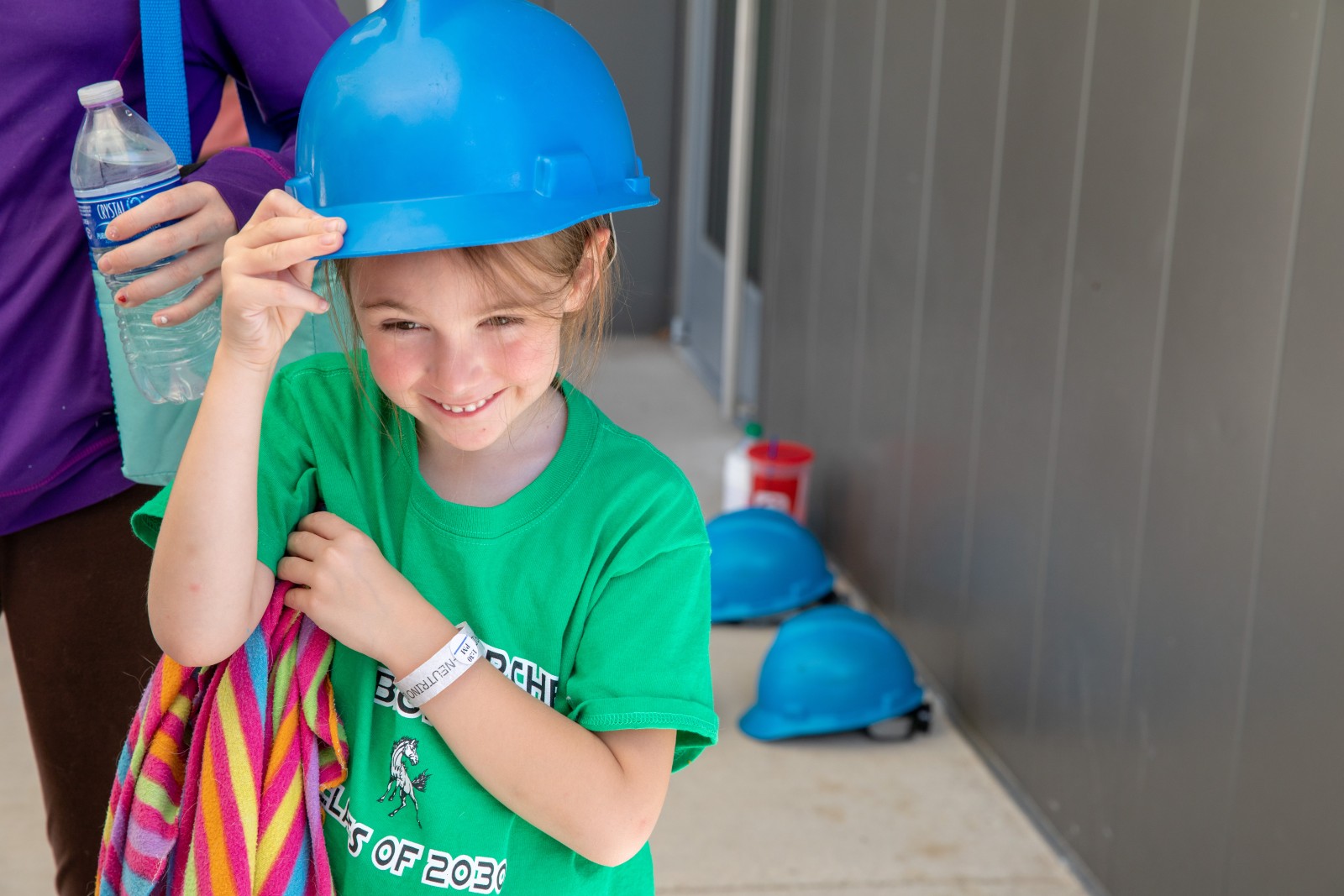 Young visitor dons a hardhat for a Hoistroom Tour on Neutrino Day 
