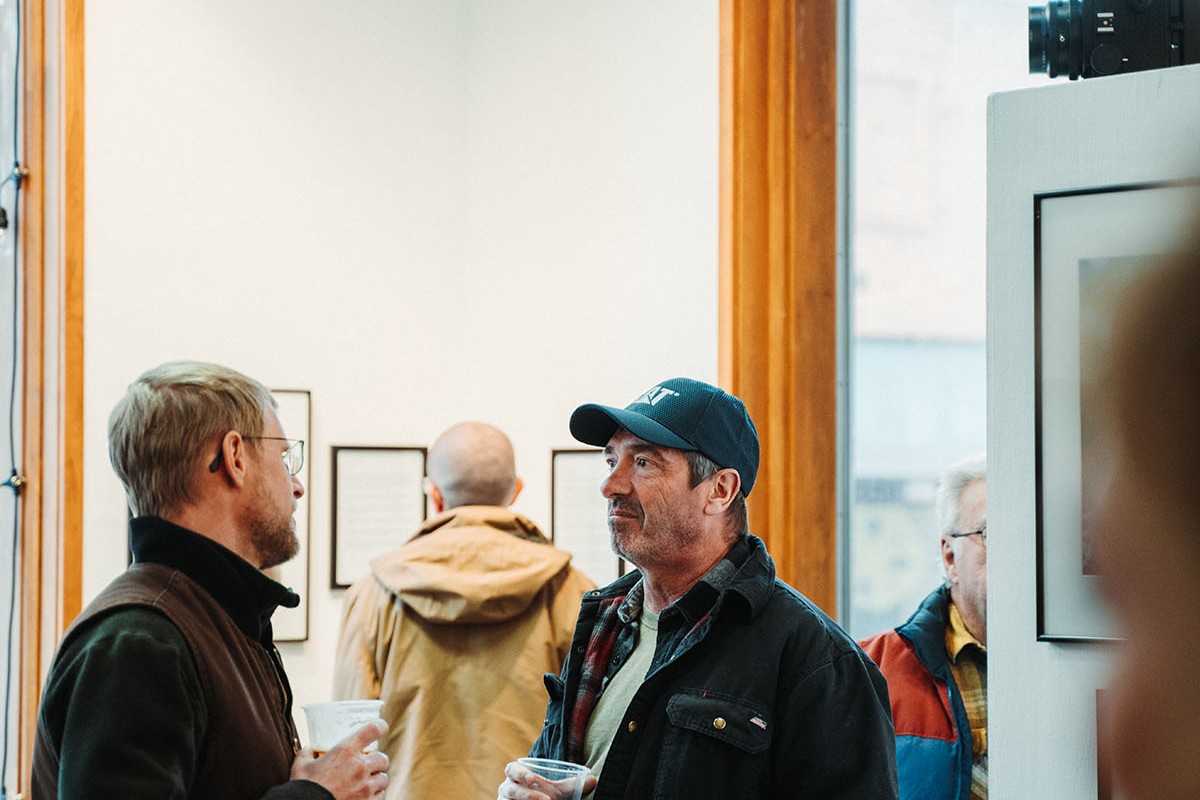 People enjoy refreshments at an art gallery
